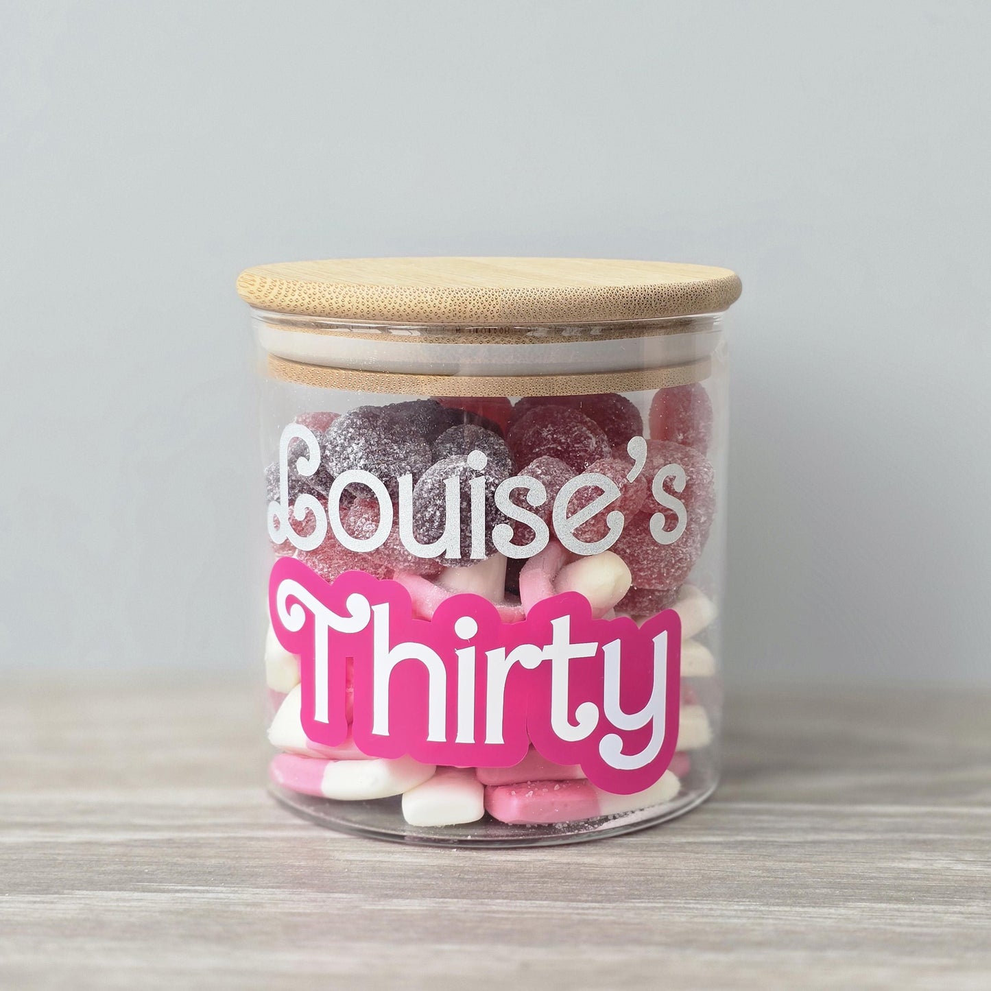 Jar of sweets with a 'Louise's Thirty' label on a light background