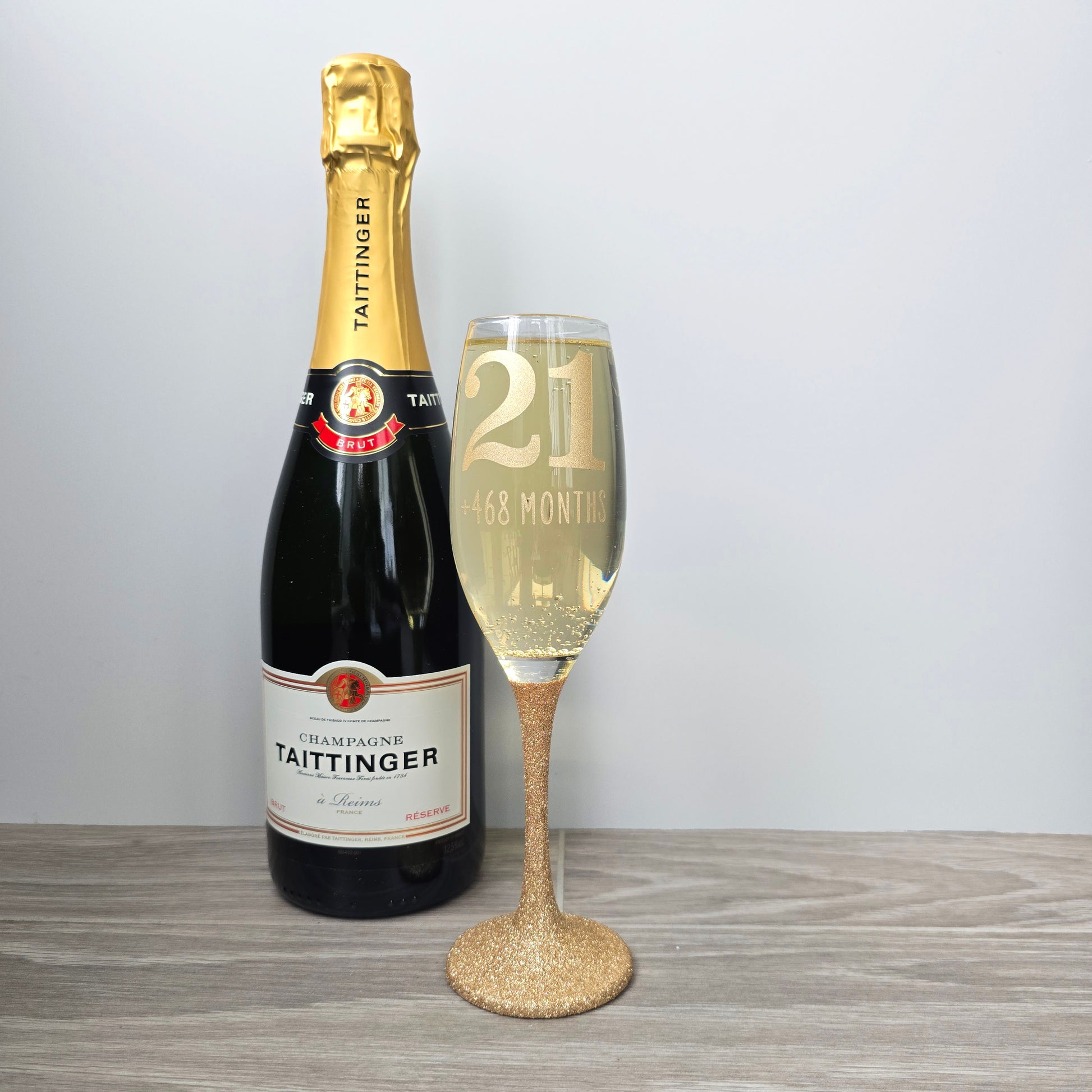 Prosecco glass or Champagne flute decorated with high shine glitter stem and personalised with 21 + the number of months to make up a 30th, 40th, 50th, 60th or 70th Birthday.