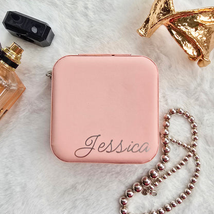 Faux leather, travel jewellery box personalised with a name in the middle in the bottom corner. Travel size jewellery case with zip and internal jewellery dividers.