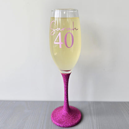 Personalised glitter stem prosecco glass or champagne flute in gold, pink, purple or Blue. Signature style custom name and an age underneath