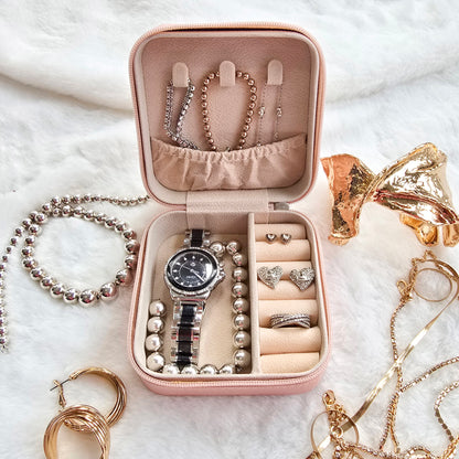 Faux leather, travel jewellery box personalised with a name in the middle of a decorative circle, decorated with hearts. Travel size jewellery case with zip and internal jewellery dividers.