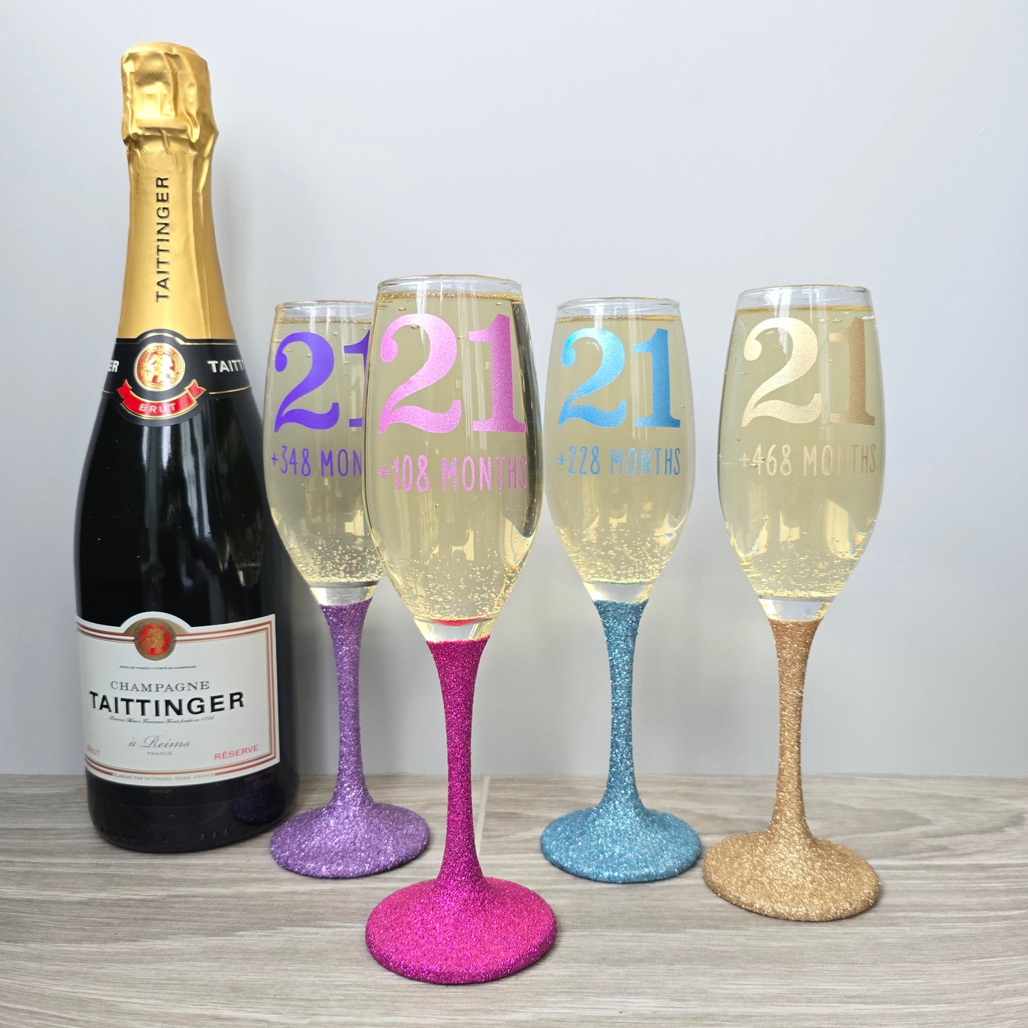Prosecco glass or Champagne flute decorated with high shine glitter stem and personalised with 21 + the number of months to make up a 30th, 40th, 50th, 60th or 70th Birthday.