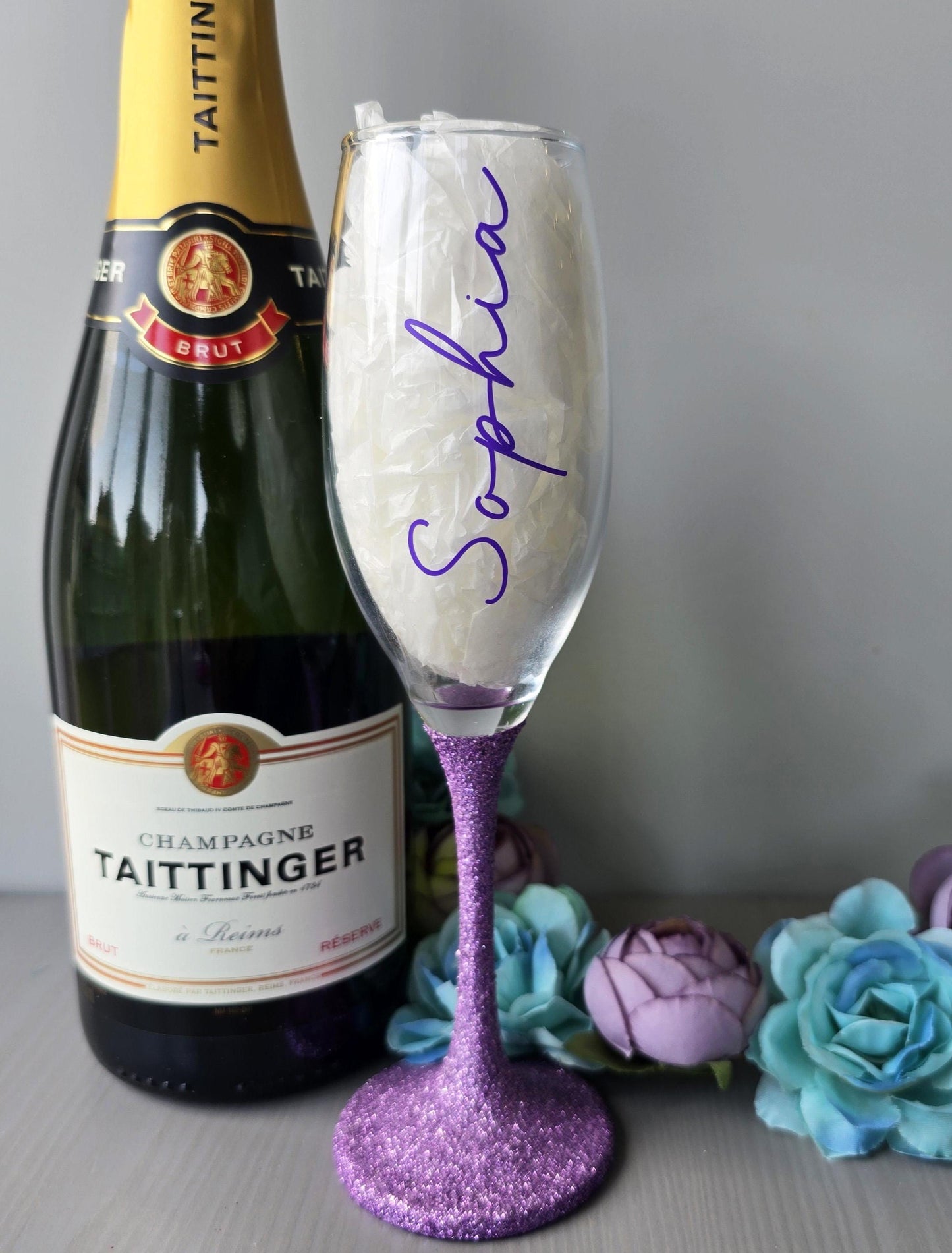 Personalised glitter stem prosecco or champagne flute glasses with a name in glitter or metallic decorative font on the side of the glass.