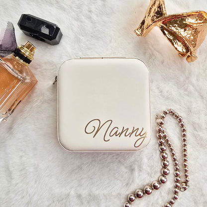 Faux leather, travel jewellery box personalised with a name in the middle in the bottom corner. Travel size jewellery case with zip and internal jewellery dividers.