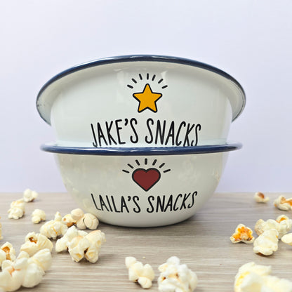 Kids Personalised white metal enamel snack bowl. White enamel metal bowl with navy blue rim. Printed with a yellow star or red heart and a name with snacks written underneath. Perfect for popcorn, sweets, crisps or general snacks.