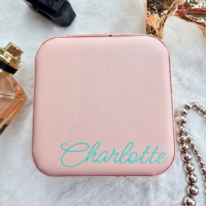 Faux leather, travel jewellery box personalised with a name in the middle in the bottom corner. Travel size jewellery case with zip and internal jewellery dividers.