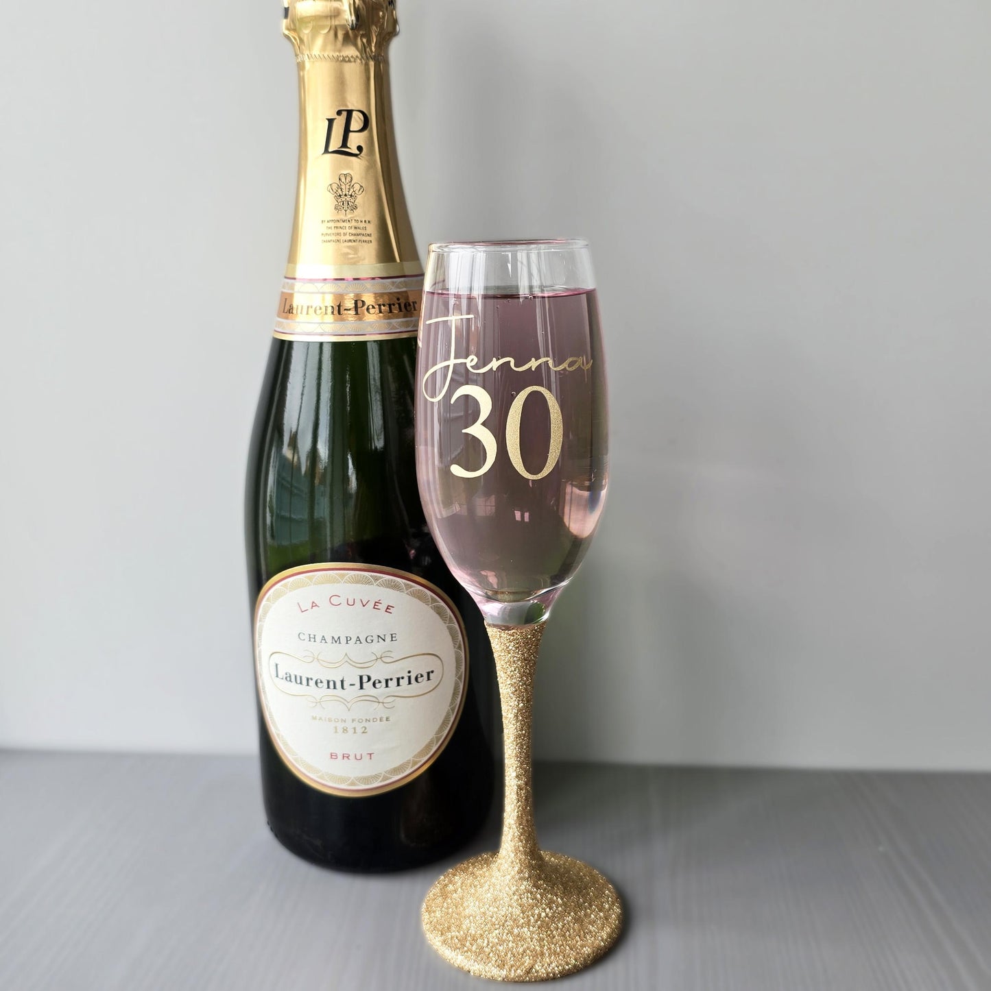 Personalised glitter stem prosecco glass or champagne flute in gold, pink, purple or Blue. Signature style custom name and an age underneath