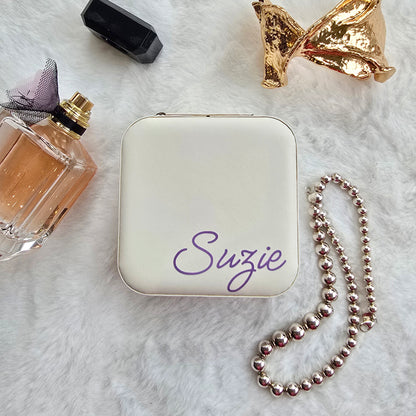 Faux leather, travel jewellery box personalised with a name in the middle in the bottom corner. Travel size jewellery case with zip and internal jewellery dividers.