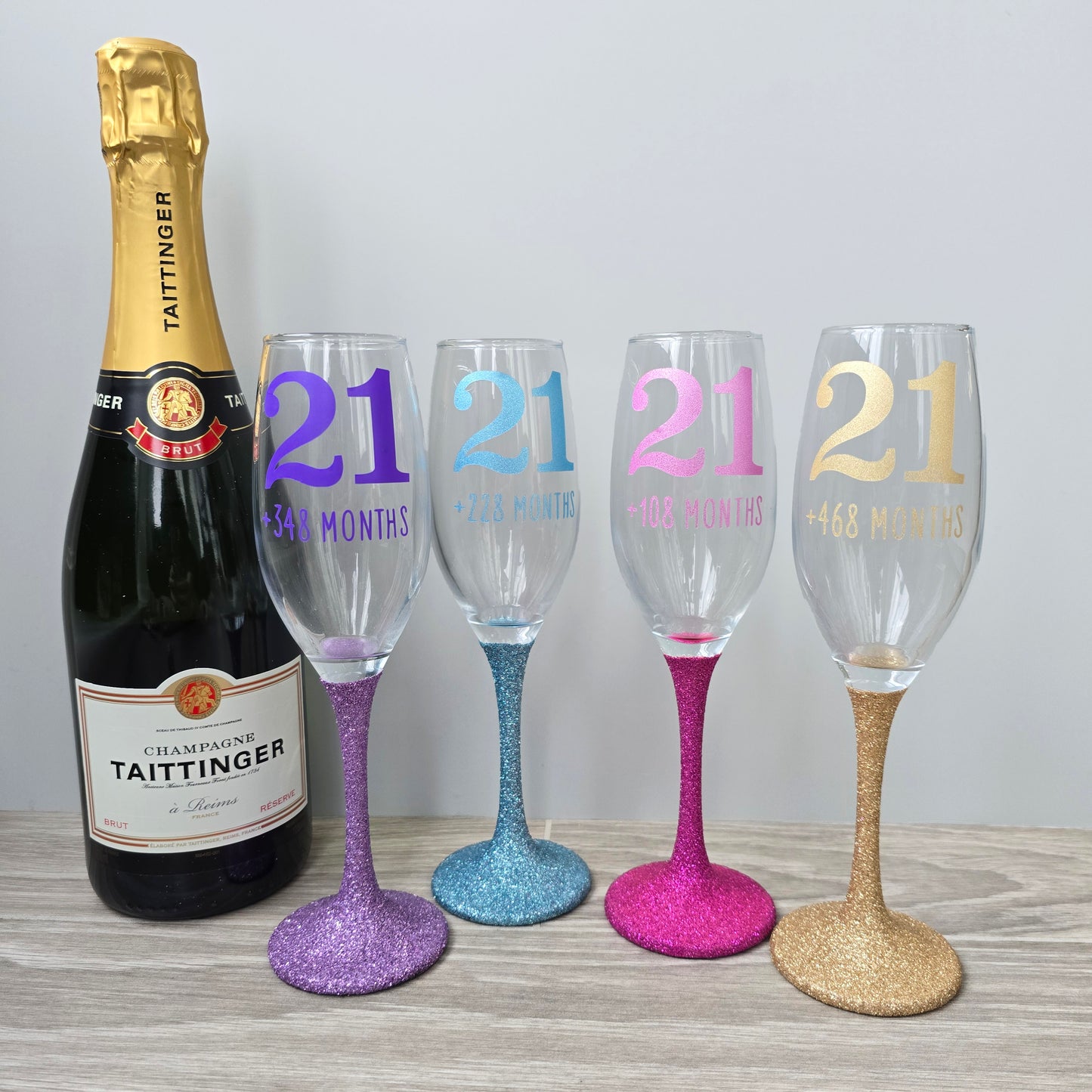 Prosecco glass or Champagne flute decorated with high shine glitter stem and personalised with 21 + the number of months to make up a 30th, 40th, 50th, 60th or 70th Birthday.