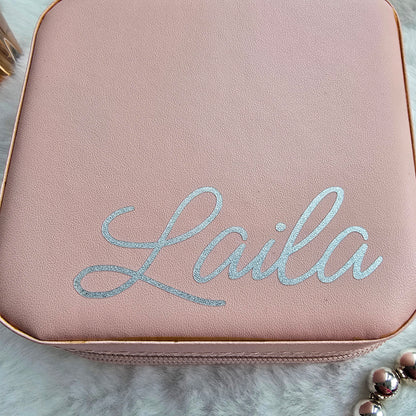 Faux leather, travel jewellery box personalised with a name in the middle in the bottom corner. Travel size jewellery case with zip and internal jewellery dividers.