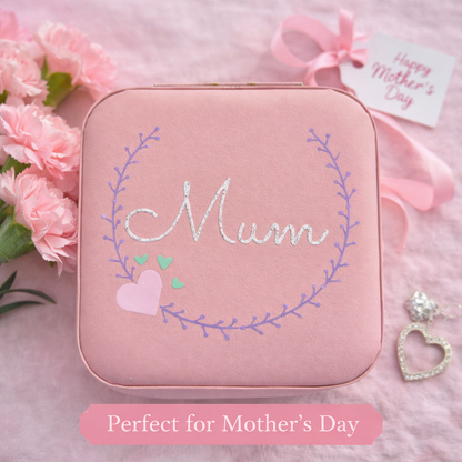 Faux leather, travel jewellery box personalised with a name in the middle of a decorative circle, decorated with hearts. Travel size jewellery case with zip and internal jewellery dividers.