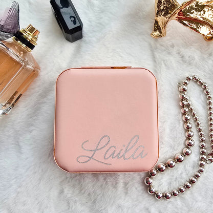 Faux leather, travel jewellery box personalised with a name in the middle in the bottom corner. Travel size jewellery case with zip and internal jewellery dividers.