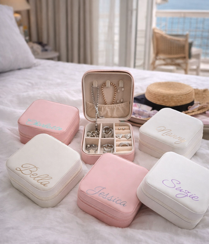 Faux leather, travel jewellery box personalised with a name in the middle in the bottom corner. Travel size jewellery case with zip and internal jewellery dividers.