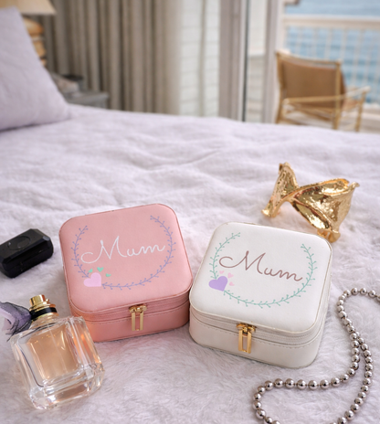 Faux leather, travel jewellery box personalised with a name in the middle of a decorative circle, decorated with hearts. Travel size jewellery case with zip and internal jewellery dividers.