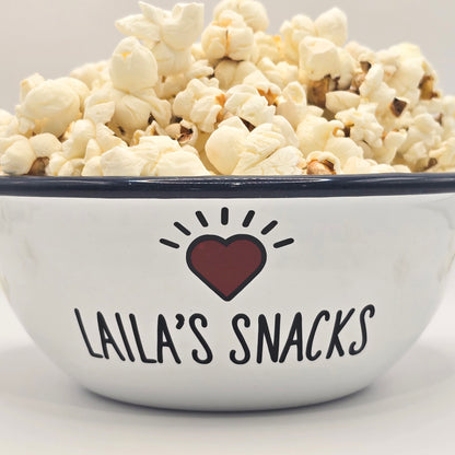 Kids Personalised white metal enamel snack bowl. White enamel metal bowl with navy blue rim. Printed with a yellow star or red heart and a name with snacks written underneath. Perfect for popcorn, sweets, crisps or general snacks.