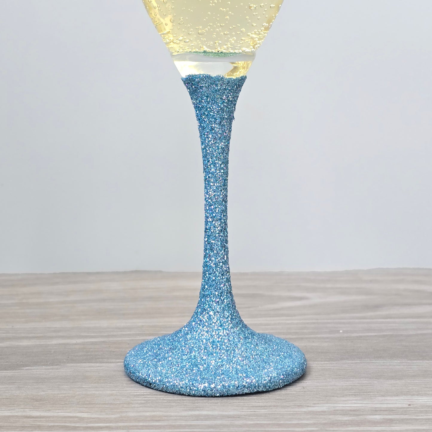 Prosecco glass or Champagne flute decorated with high shine glitter stem and personalised with 21 + the number of months to make up a 30th, 40th, 50th, 60th or 70th Birthday.