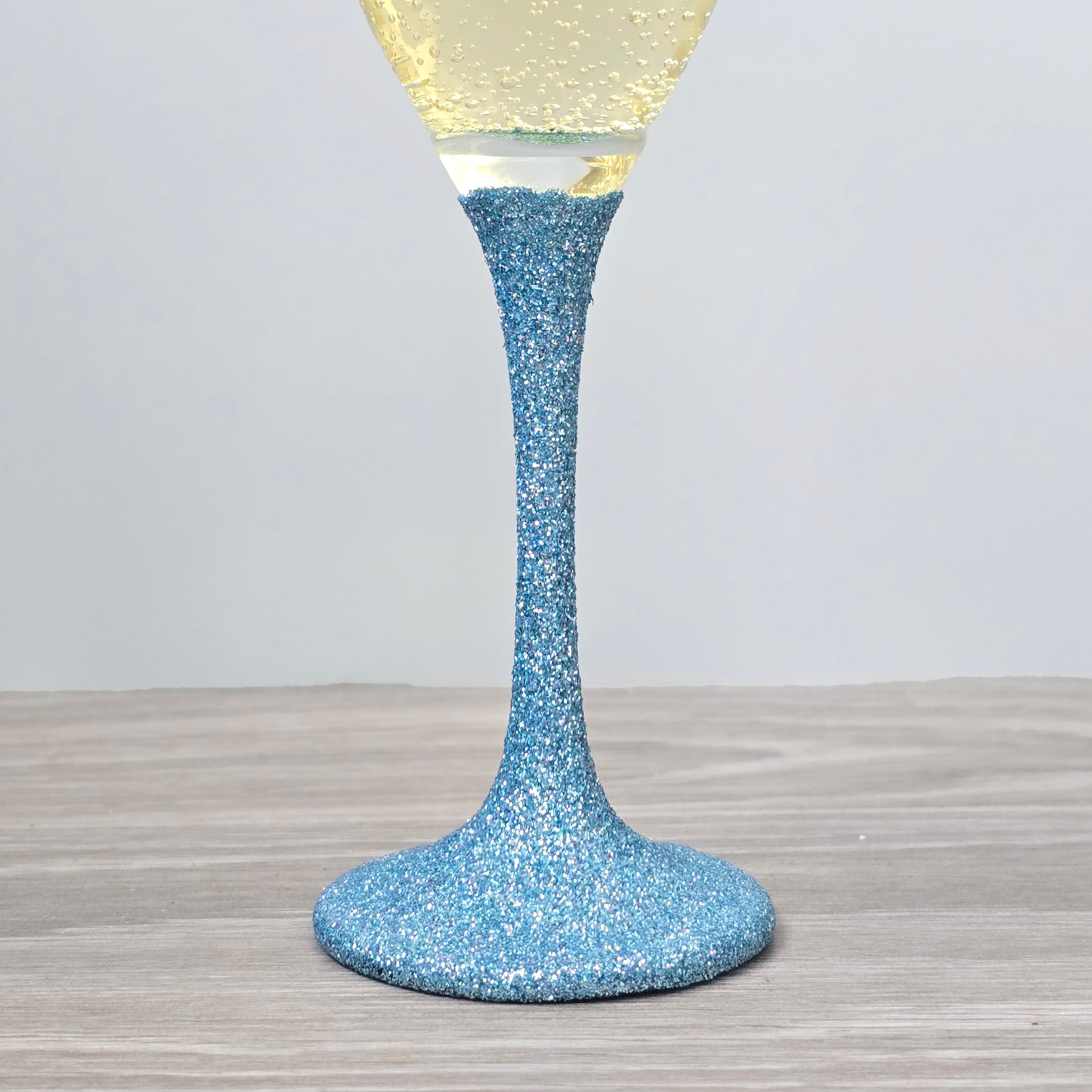 Prosecco glass or Champagne flute decorated with high shine glitter stem and personalised with 21 + the number of months to make up a 30th, 40th, 50th, 60th or 70th Birthday.