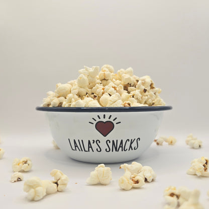 Kids Personalised white metal enamel snack bowl. White enamel metal bowl with navy blue rim. Printed with a yellow star or red heart and a name with snacks written underneath. Perfect for popcorn, sweets, crisps or general snacks.