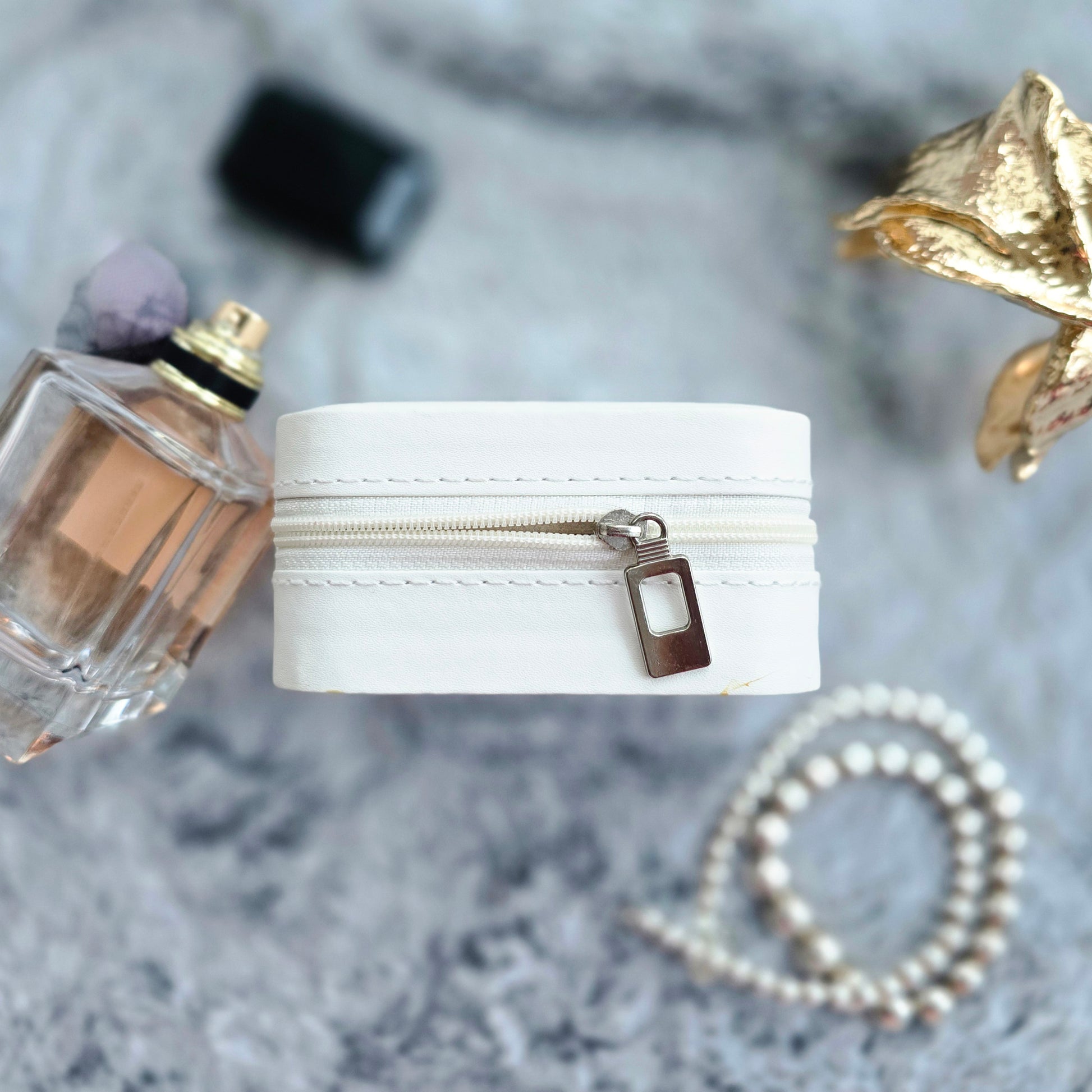 Faux leather, travel jewellery box personalised with a name in the middle in the bottom corner. Travel size jewellery case with zip and internal jewellery dividers.