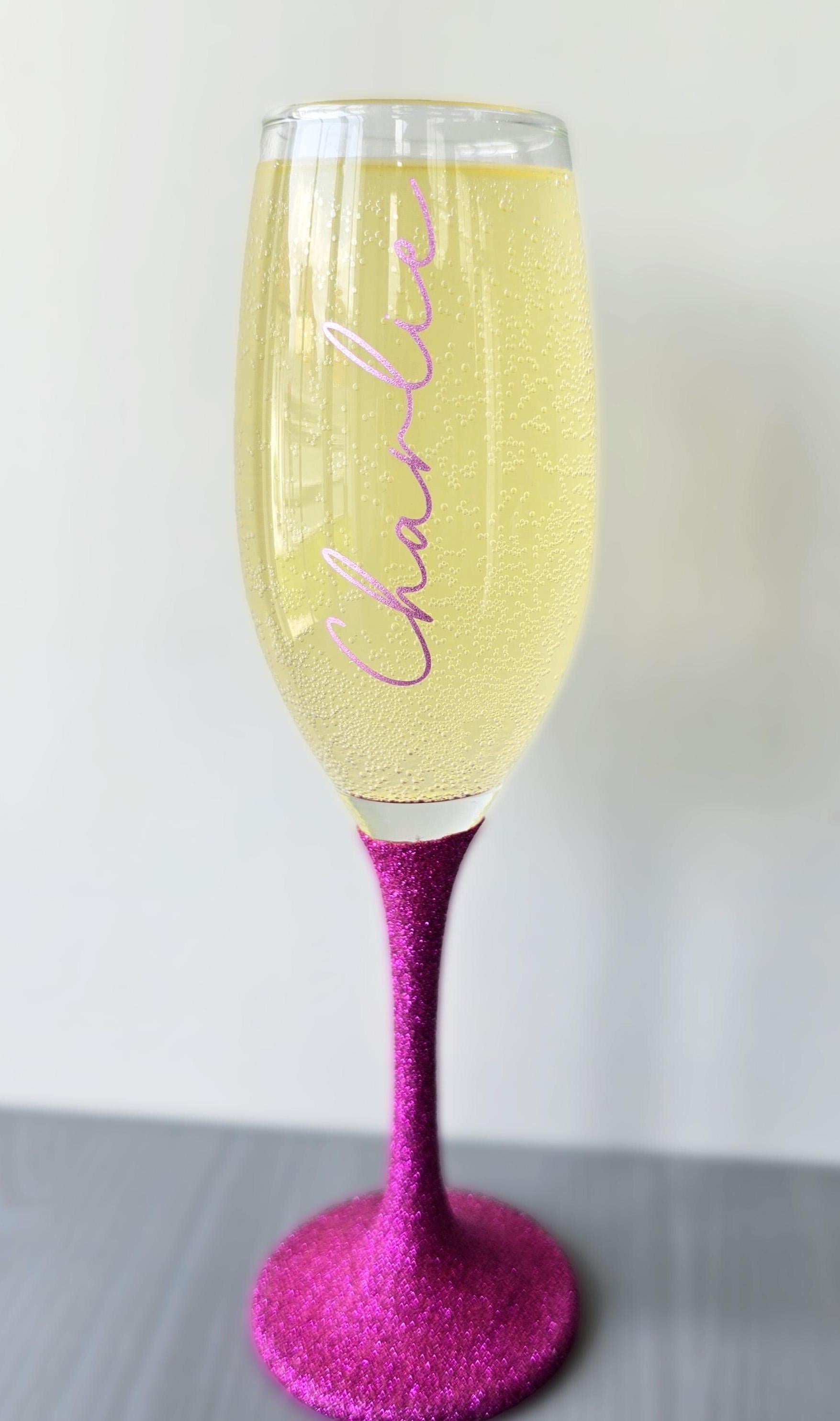 Personalised glitter stem prosecco or champagne flute glasses with a name in glitter or metallic decorative font on the side of the glass.