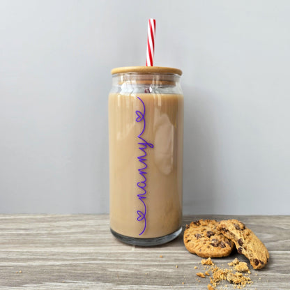 Personalised glass can drink tumbler with a bamboo suction lid and red and white reusable straw. Name printed in decorative font, in a range of colours, printed along the glass.