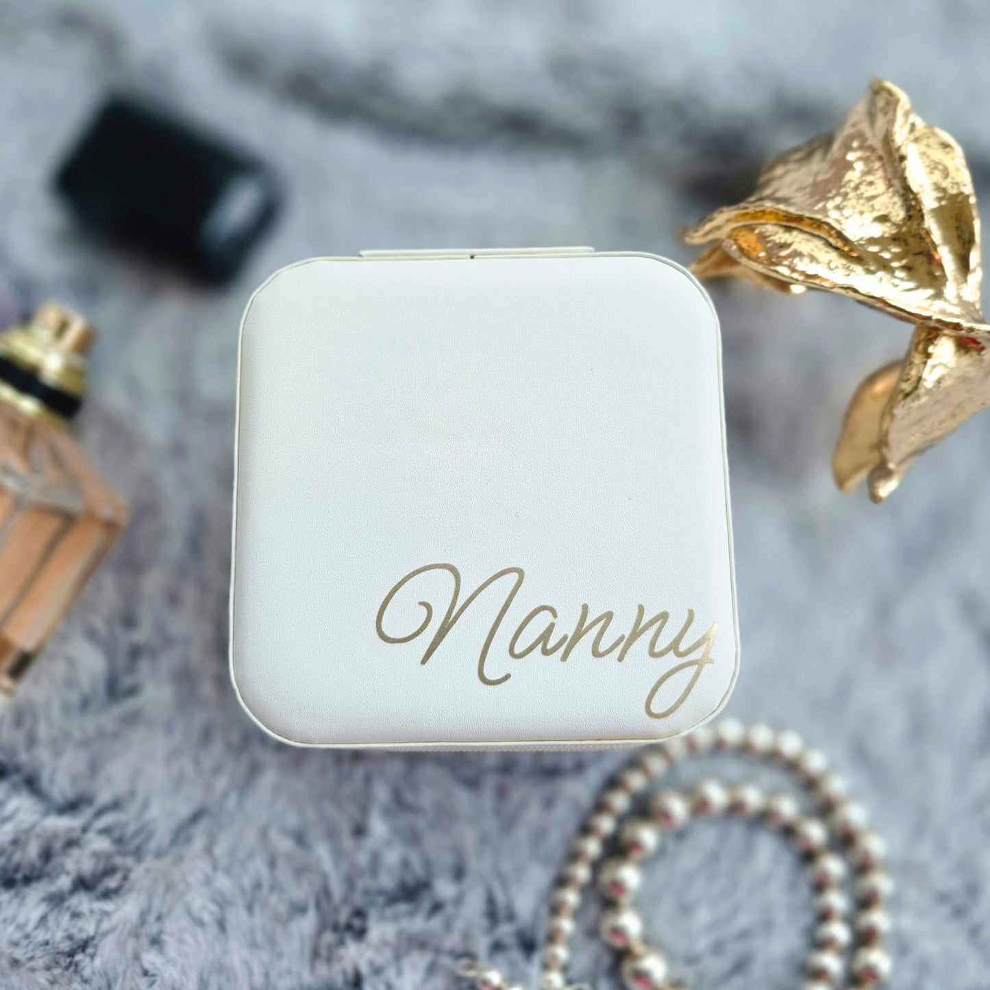 Faux leather, travel jewellery box personalised with a name in the middle in the bottom corner. Travel size jewellery case with zip and internal jewellery dividers.