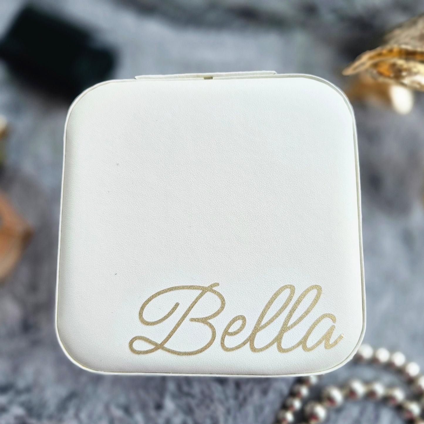 Faux leather, travel jewellery box personalised with a name in the middle in the bottom corner. Travel size jewellery case with zip and internal jewellery dividers.