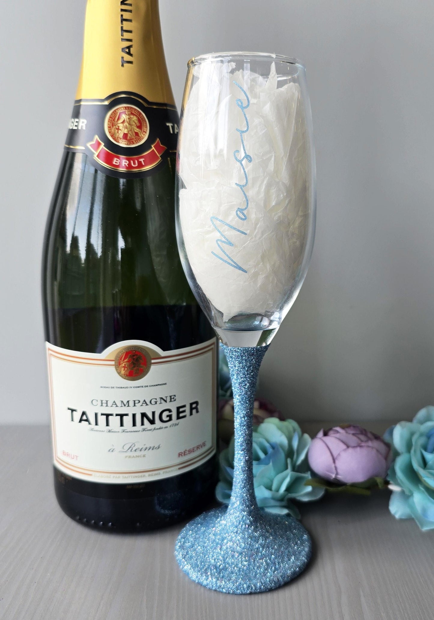 Personalised glitter stem prosecco or champagne flute glasses with a name in glitter or metallic decorative font on the side of the glass.