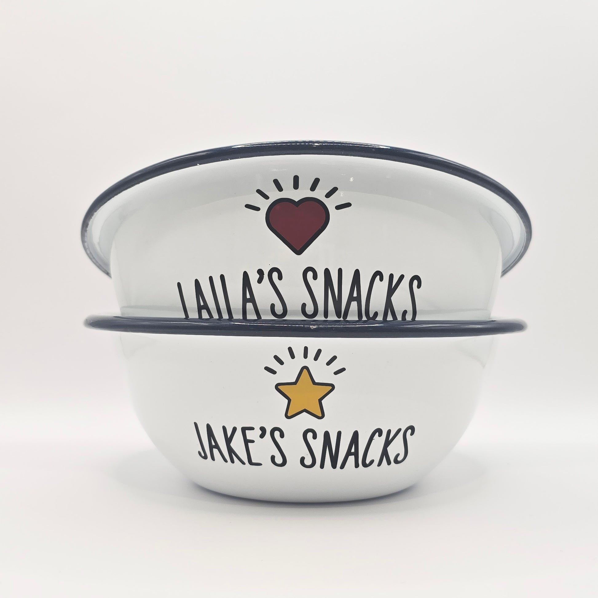 Kids Personalised white metal enamel snack bowl. White enamel metal bowl with navy blue rim. Printed with a yellow star or red heart and a name with snacks written underneath. Perfect for popcorn, sweets, crisps or general snacks.