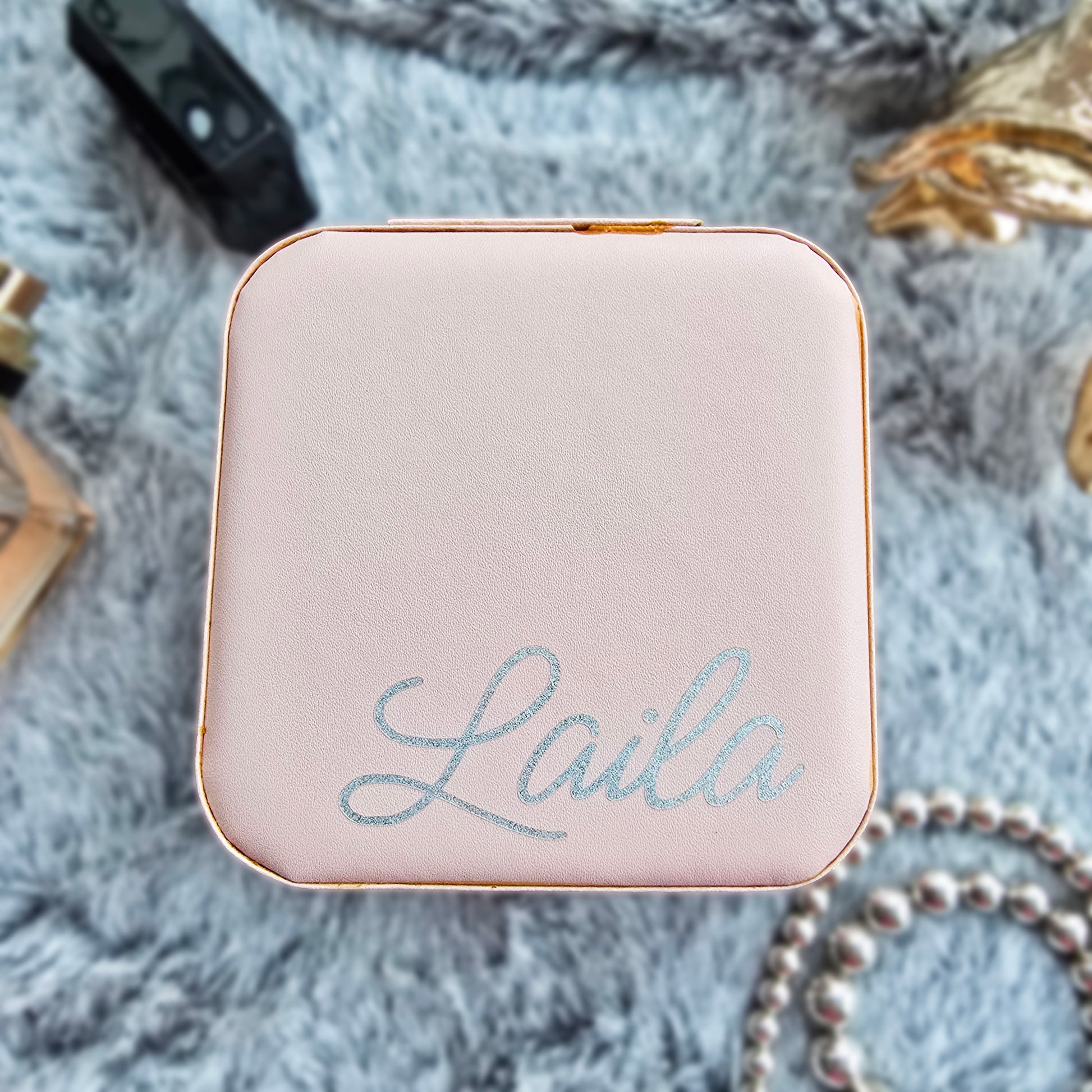 Faux leather, travel jewellery box personalised with a name in the middle in the bottom corner. Travel size jewellery case with zip and internal jewellery dividers.