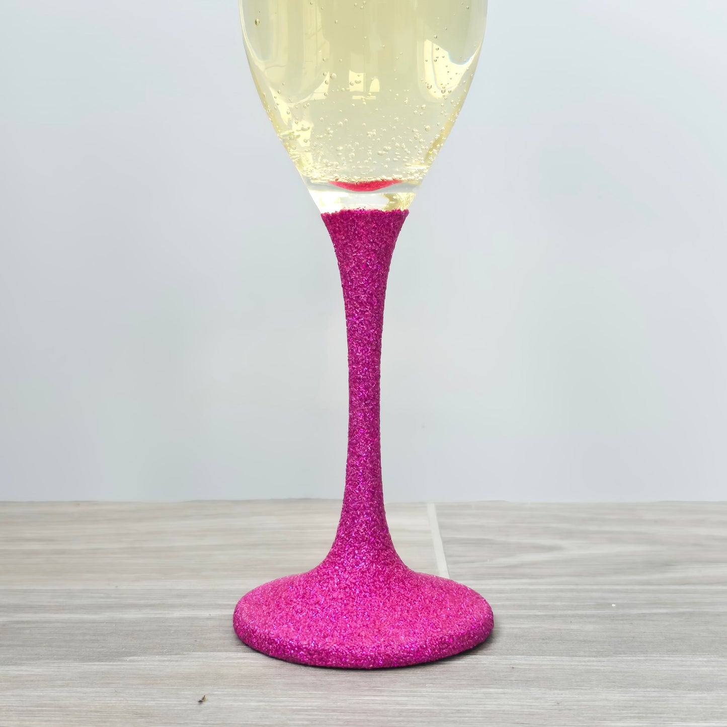 Prosecco glass or Champagne flute decorated with high shine glitter stem and personalised with 21 + the number of months to make up a 30th, 40th, 50th, 60th or 70th Birthday.