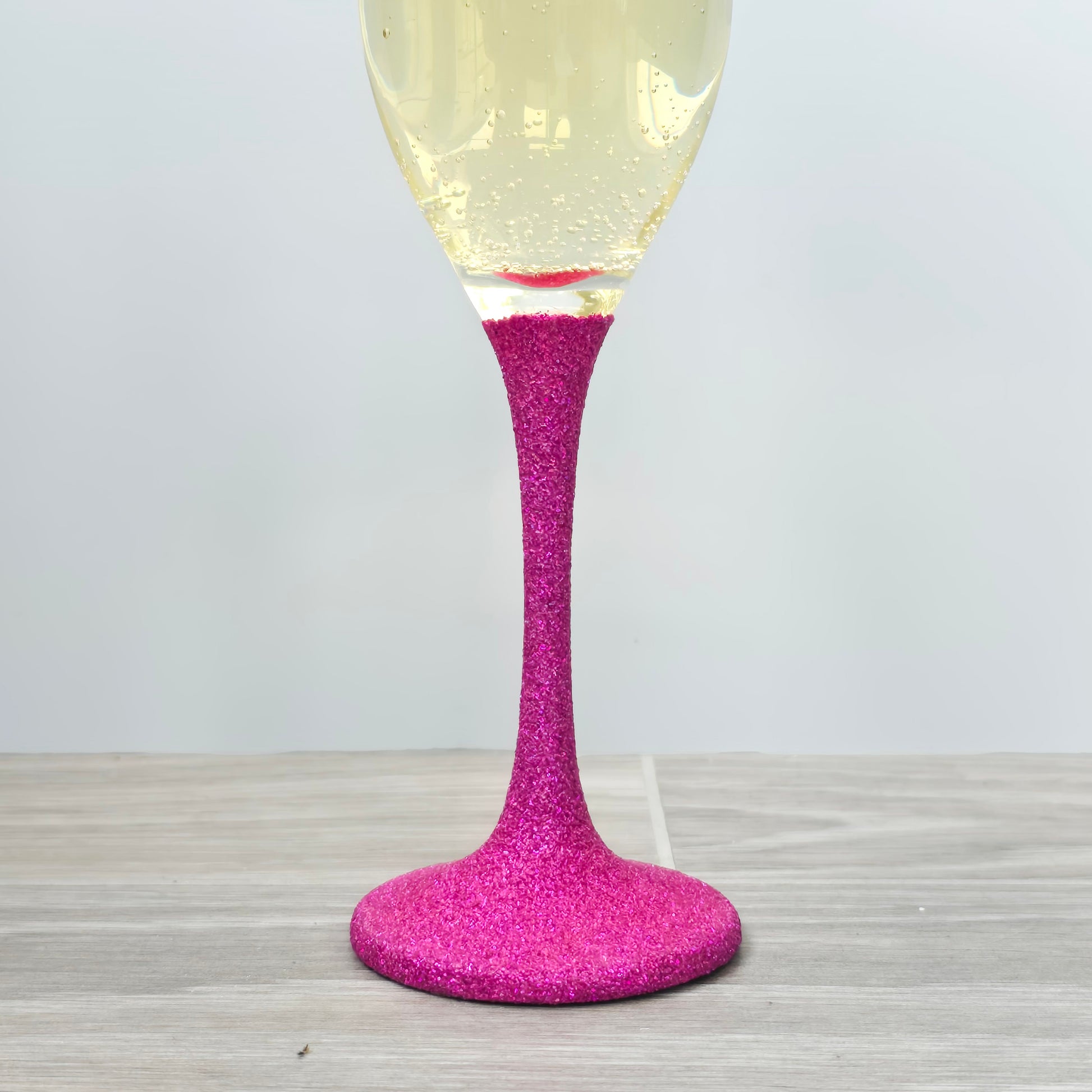 Prosecco glass or Champagne flute decorated with high shine glitter stem and personalised with 21 + the number of months to make up a 30th, 40th, 50th, 60th or 70th Birthday.