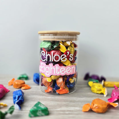 Jar of colorful candies with 'Chloe's Eighteen' text on a light gray background