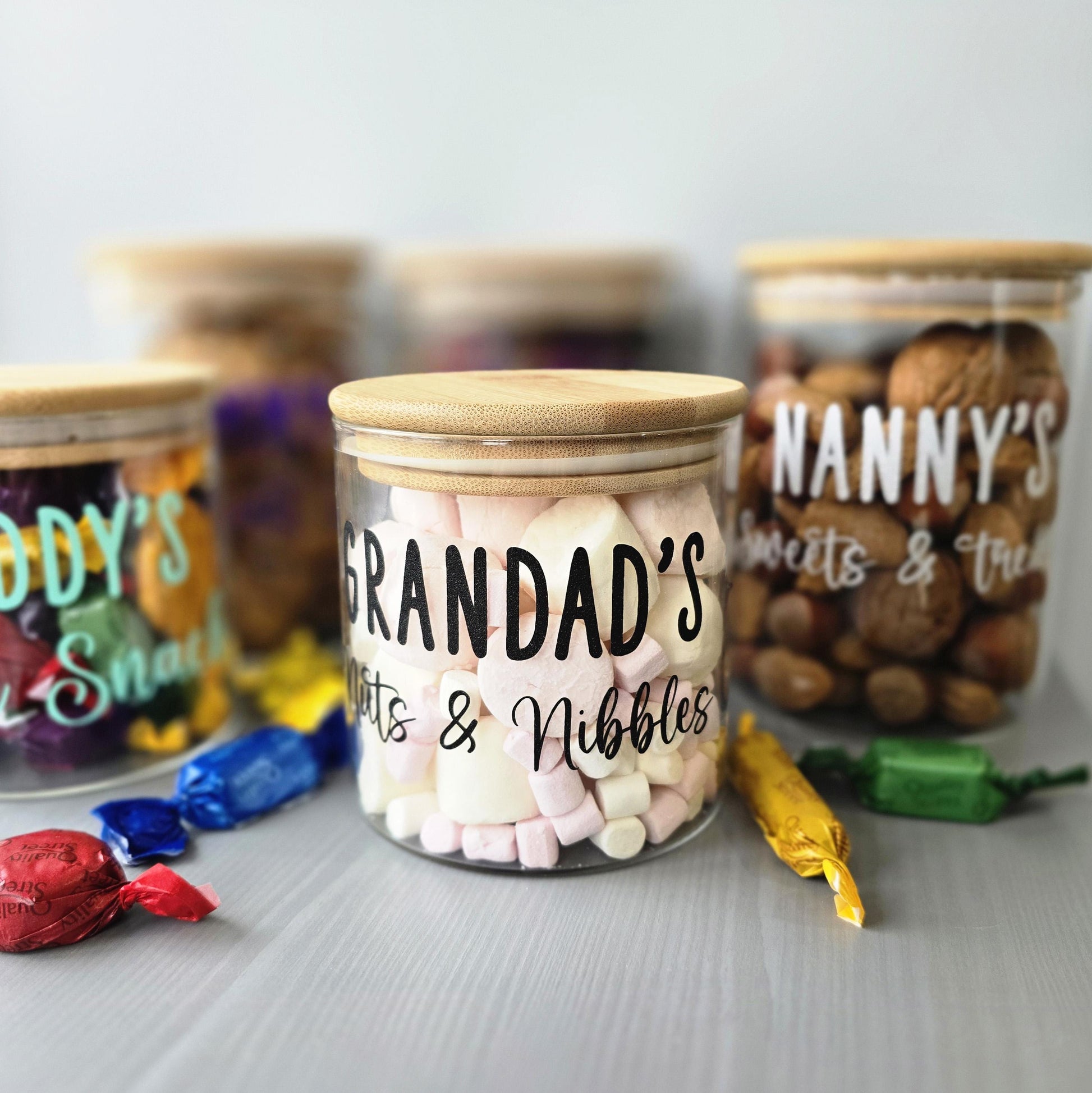 Jar labeled 'Grandad's Sweets & Nibbles' with other labeled jars in the background.