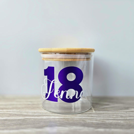 Personalised glass jar with wooden suction lid with a large age and name in purple and silver vinyl