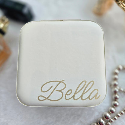Faux leather, travel jewellery box personalised with a name in the middle in the bottom corner. Travel size jewellery case with zip and internal jewellery dividers.