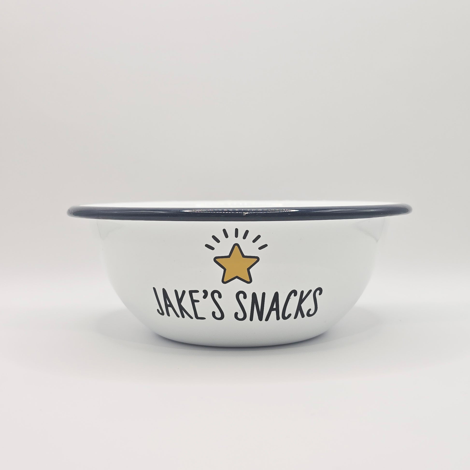 Kids Personalised white metal enamel snack bowl. White enamel metal bowl with navy blue rim. Printed with a yellow star or red heart and a name with snacks written underneath. Perfect for popcorn, sweets, crisps or general snacks.