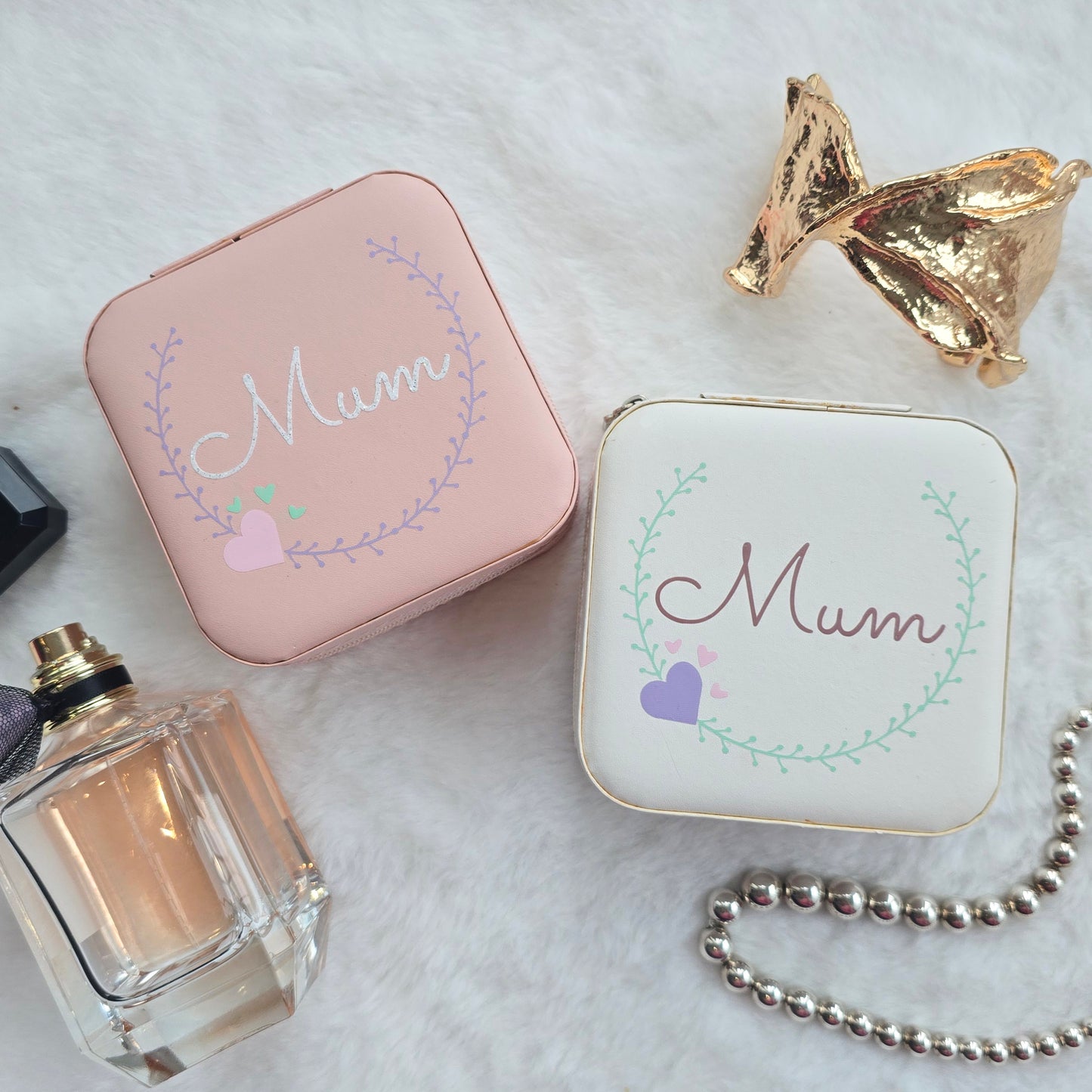 Faux leather, travel jewellery box personalised with a name in the middle of a decorative circle, decorated with hearts. Travel size jewellery case with zip and internal jewellery dividers.