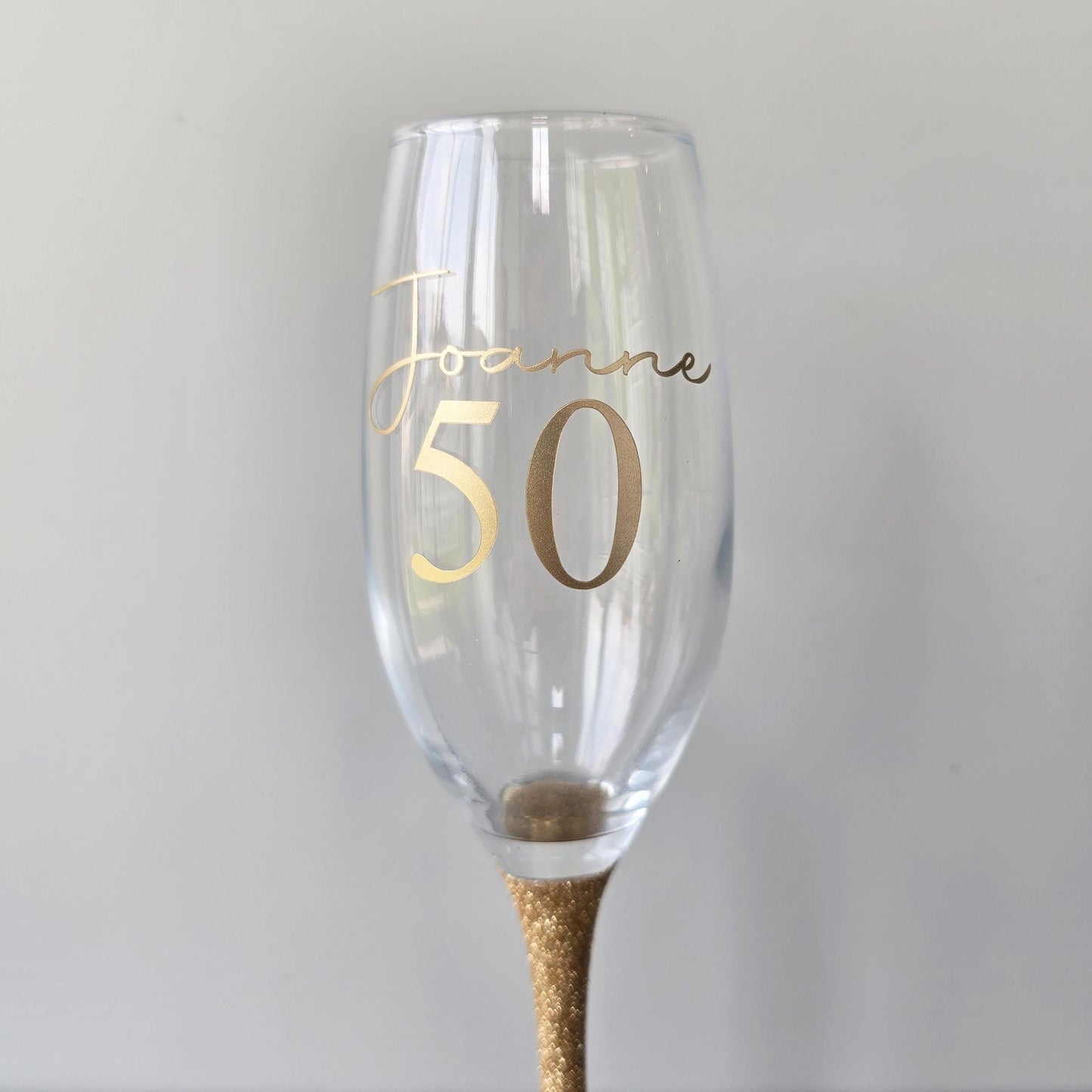 Personalised glitter stem prosecco glass or champagne flute in gold, pink, purple or Blue. Signature style custom name and an age underneath