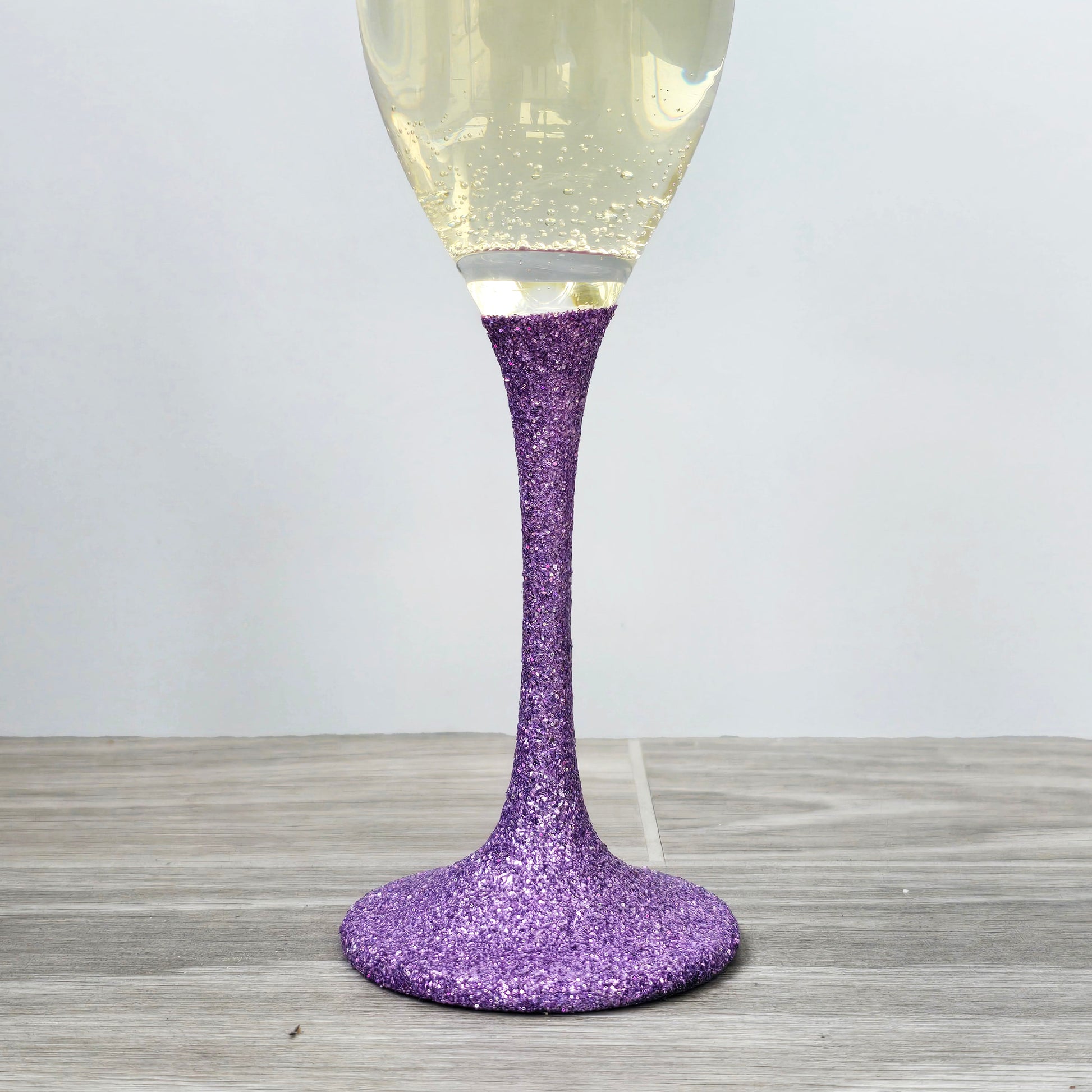 Prosecco glass or Champagne flute decorated with high shine glitter stem and personalised with 21 + the number of months to make up a 30th, 40th, 50th, 60th or 70th Birthday.
