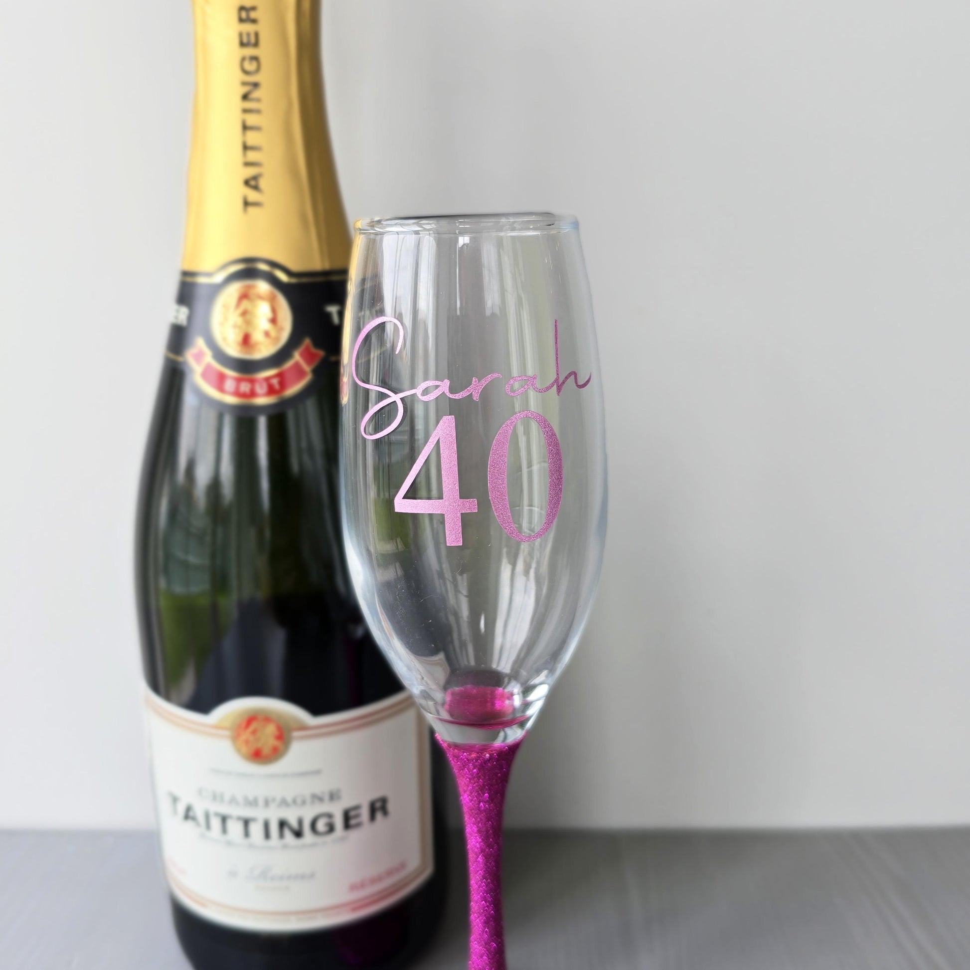 Personalised glitter stem prosecco glass or champagne flute in gold, pink, purple or Blue. Signature style custom name and an age underneath