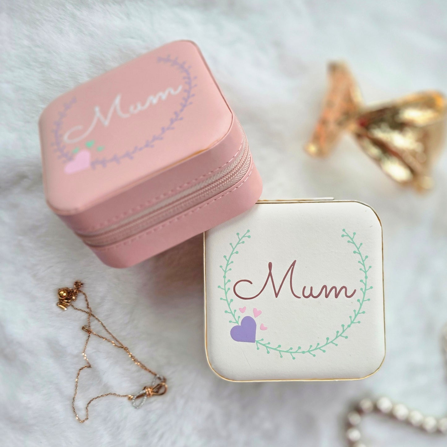 Faux leather, travel jewellery box personalised with a name in the middle of a decorative circle, decorated with hearts. Travel size jewellery case with zip and internal jewellery dividers.