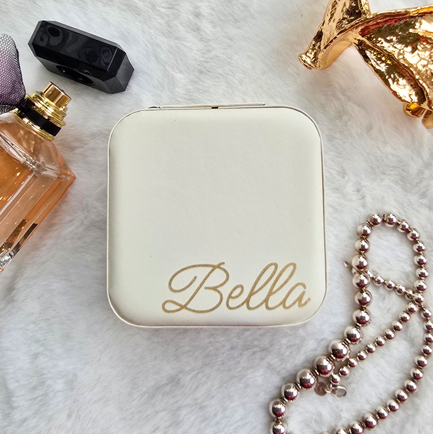 Faux leather, travel jewellery box personalised with a name in the middle in the bottom corner. Travel size jewellery case with zip and internal jewellery dividers.