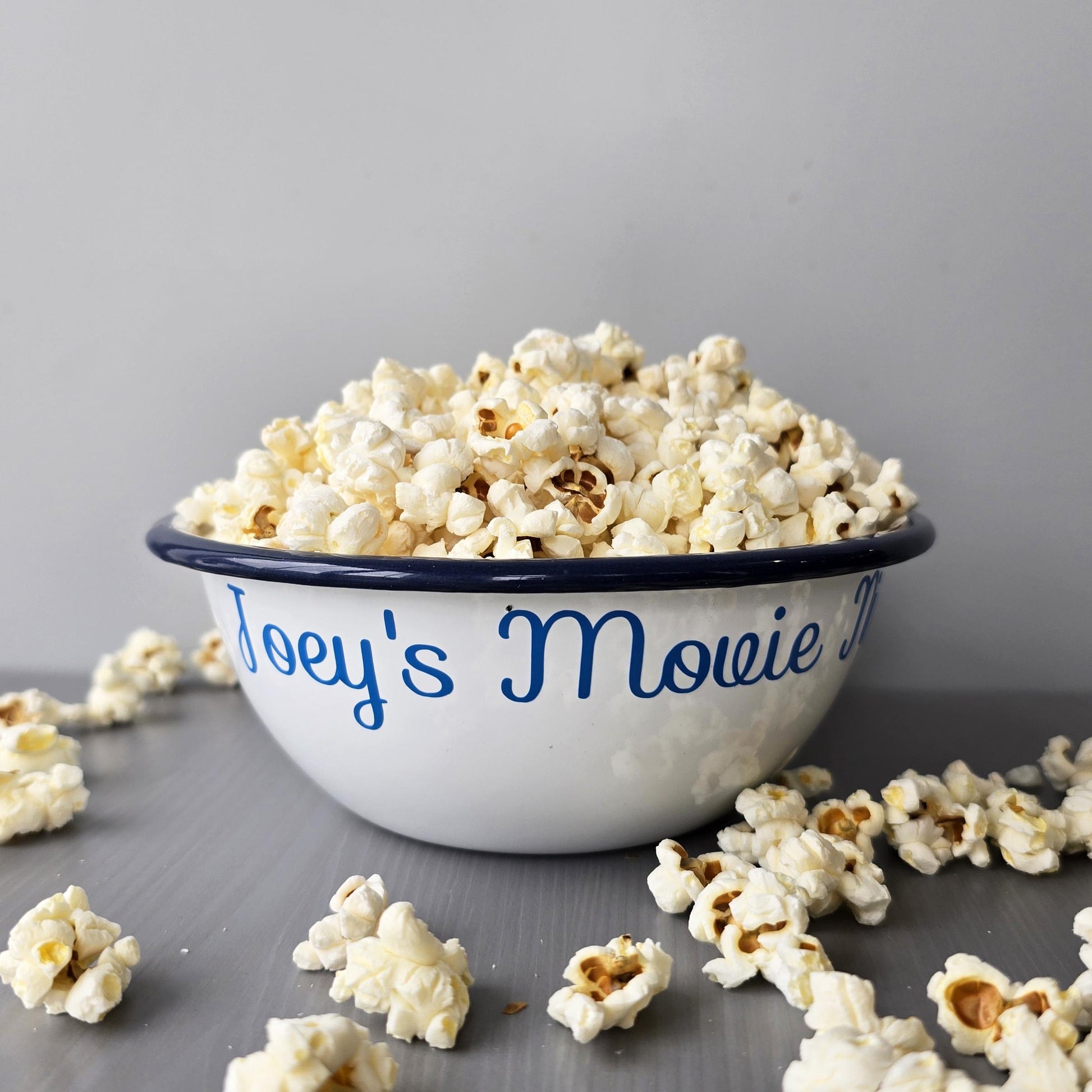 White steel enamel metal snack bowls with sofa snacks printed in blue decorative font.