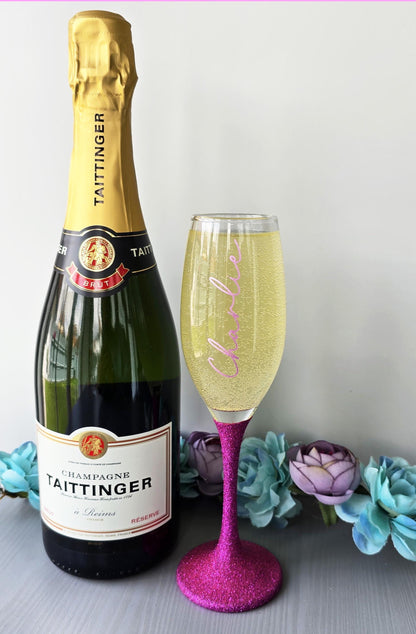 Personalised glitter stem prosecco or champagne flute glasses with a name in glitter or metallic decorative font on the side of the glass.