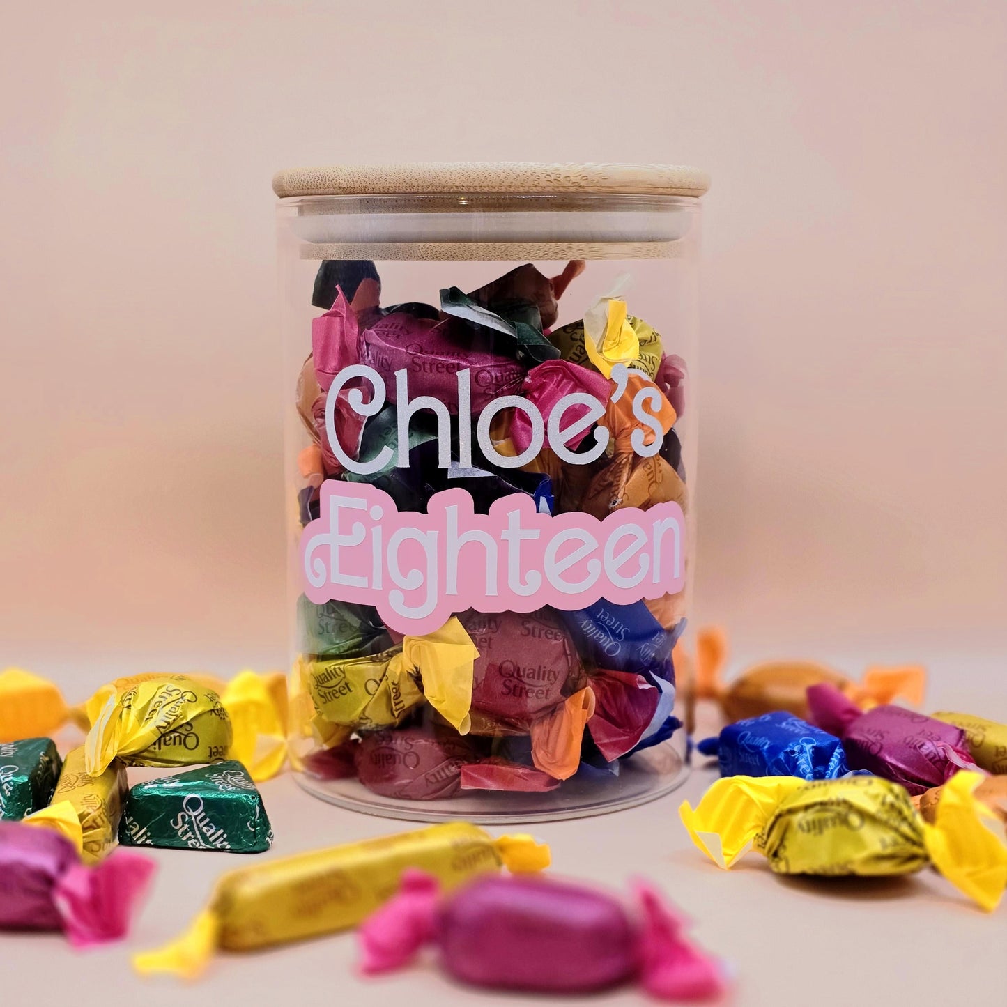 Jar of colorful candies with 'Chloe's Eighteenth' text on a light background