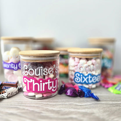 Decorative jars with personalized labels on a table