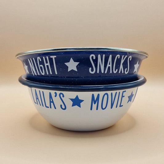 Personalised enamel snack bowls. One is blue with white name and Movie Night Snack and a white enamel bowl with blue Movie Night Snacks with a star between each word.