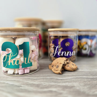 Personalised glass jar with wooden suction lid with names and numbers on a wooden surface